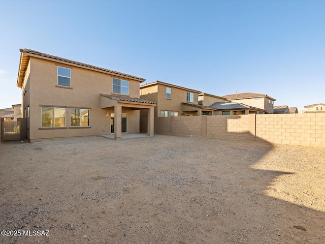 back of house with a patio