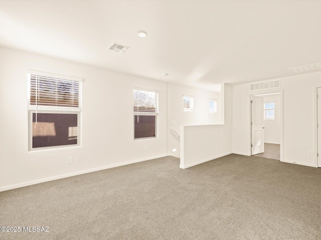 carpeted spare room with plenty of natural light