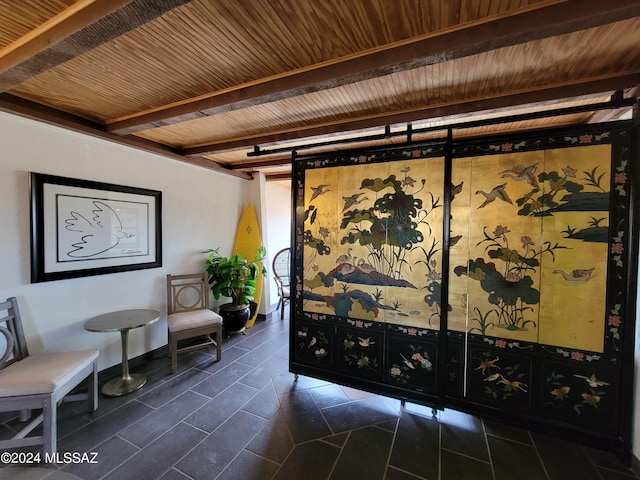 unfurnished room featuring wood ceiling and beam ceiling