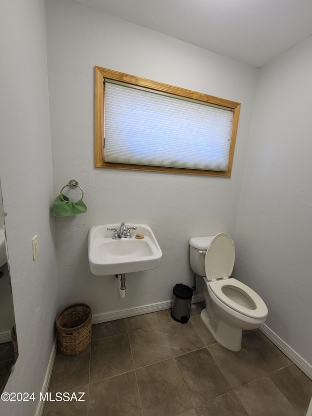 bathroom featuring tile patterned floors, toilet, and sink