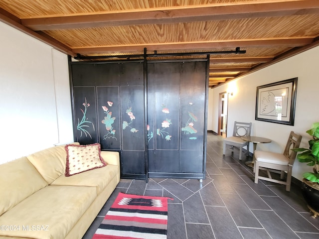 tiled living room featuring beamed ceiling, a barn door, and wood ceiling