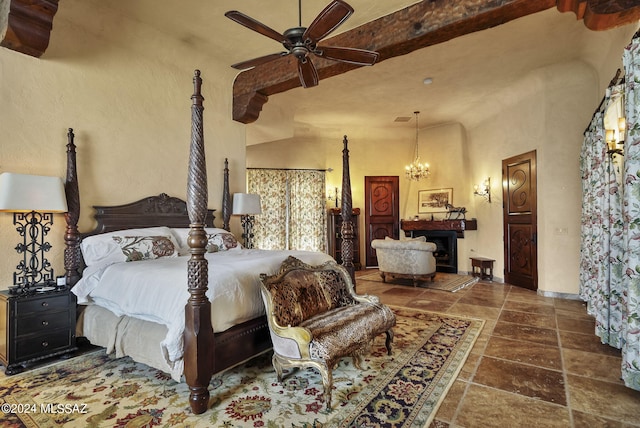 bedroom featuring ceiling fan with notable chandelier and vaulted ceiling