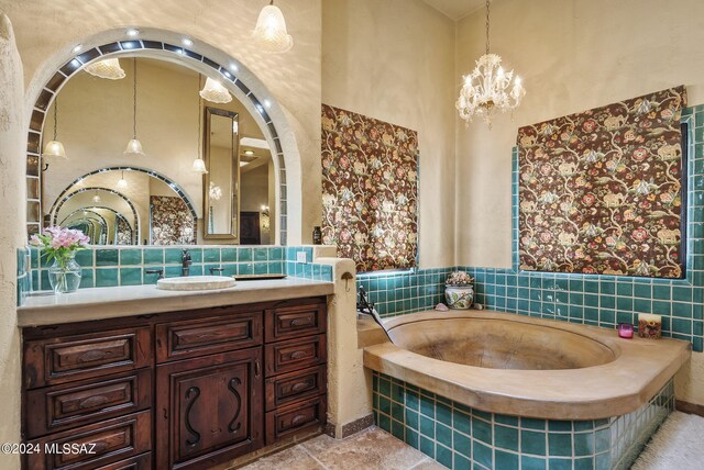 bathroom featuring vanity, decorative backsplash, and a relaxing tiled tub