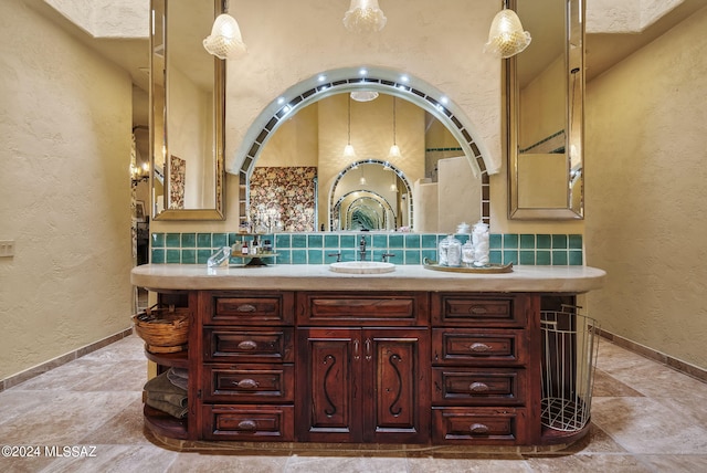 bathroom featuring decorative backsplash and vanity