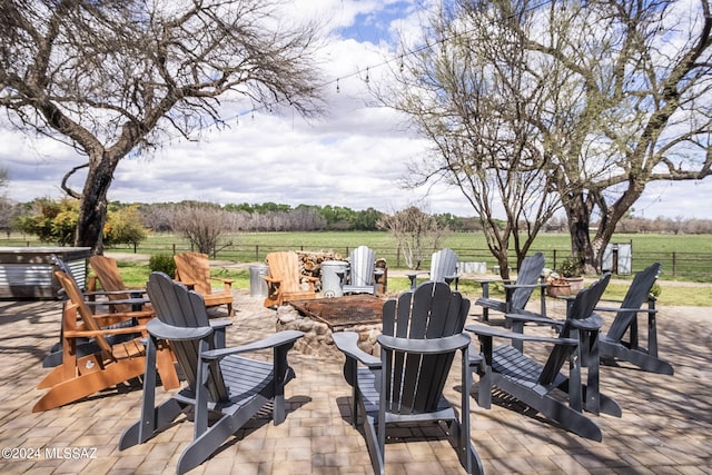 view of patio featuring a rural view and an outdoor fire pit