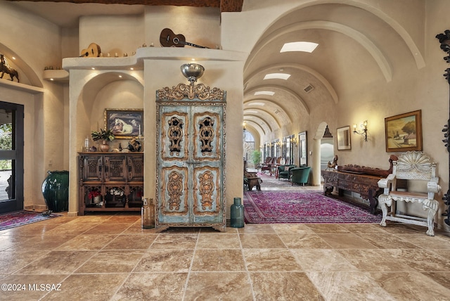 foyer entrance featuring high vaulted ceiling