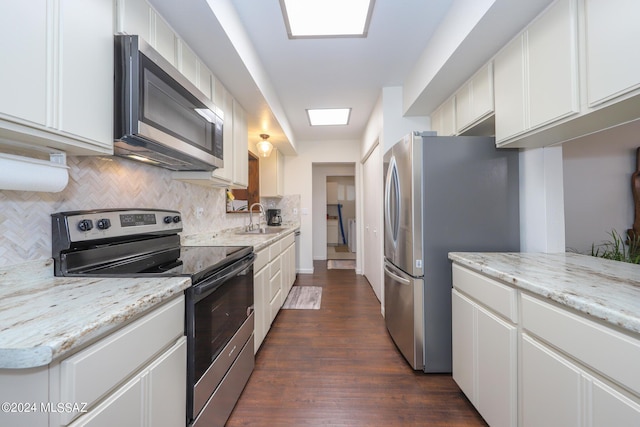 kitchen featuring white cabinets, sink, appliances with stainless steel finishes, tasteful backsplash, and dark hardwood / wood-style flooring