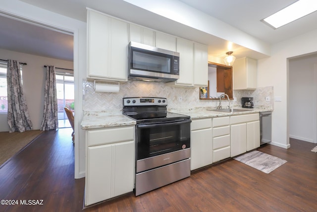 kitchen featuring sink, dark hardwood / wood-style floors, light stone countertops, appliances with stainless steel finishes, and white cabinetry