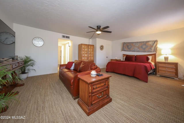 bedroom with ceiling fan and light carpet