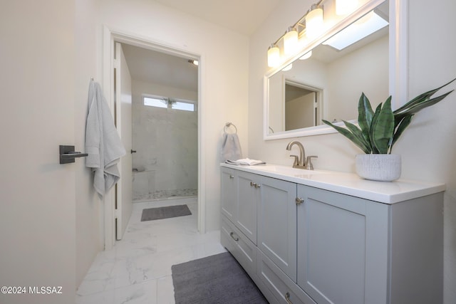 bathroom featuring vanity, a skylight, and walk in shower