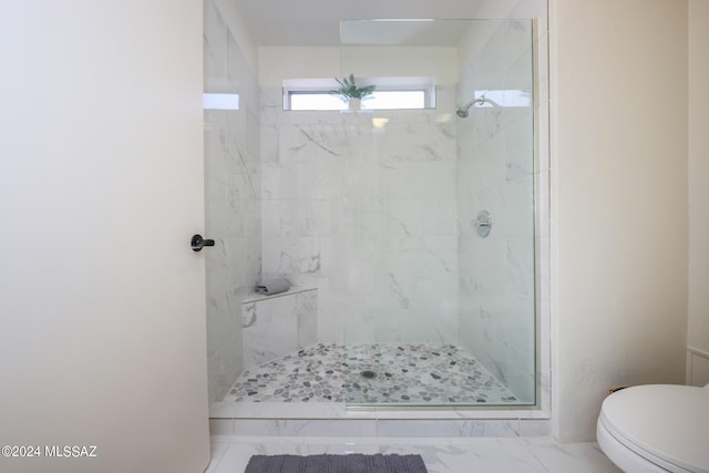 bathroom with toilet and tiled shower