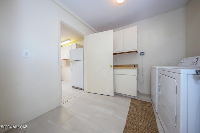 laundry area with cabinets and independent washer and dryer