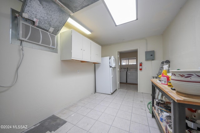 laundry area with washing machine and clothes dryer and electric panel