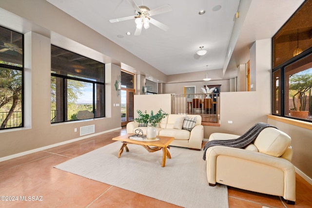 tiled living room featuring ceiling fan and a healthy amount of sunlight