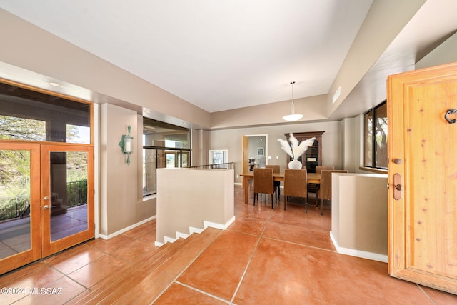 interior space with tile patterned flooring and french doors