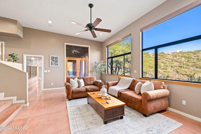 tiled living room with ceiling fan