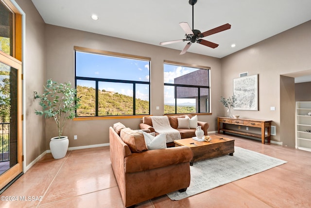 living room featuring light tile patterned floors and ceiling fan