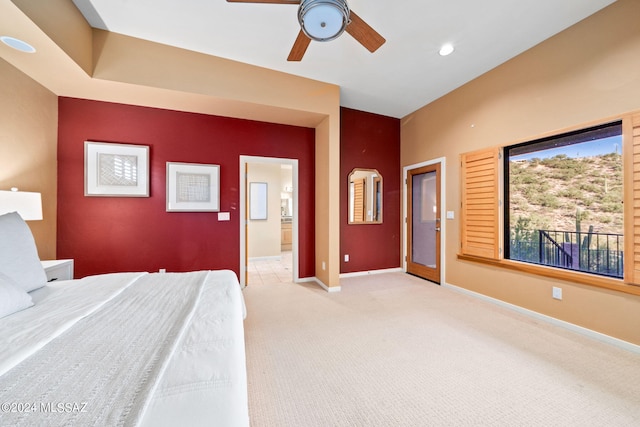 unfurnished bedroom featuring ensuite bathroom, ceiling fan, and light colored carpet