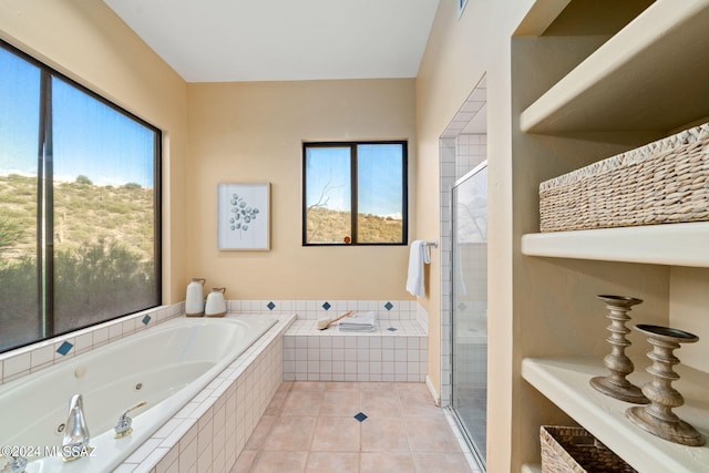 bathroom featuring tile patterned flooring, plenty of natural light, and independent shower and bath