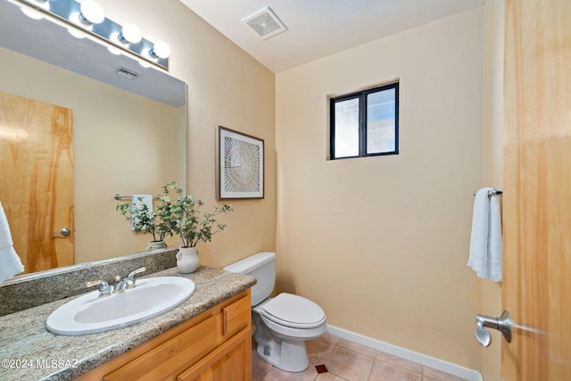 bathroom with tile patterned floors, vanity, and toilet