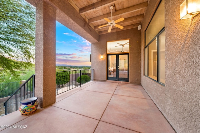 patio terrace at dusk featuring ceiling fan