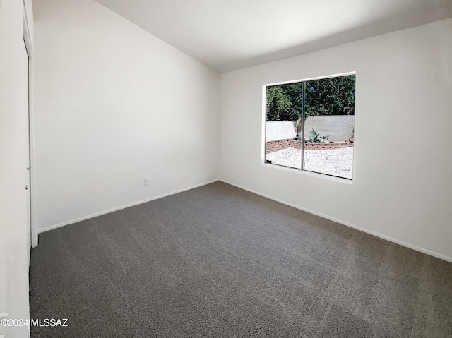 empty room with dark carpet