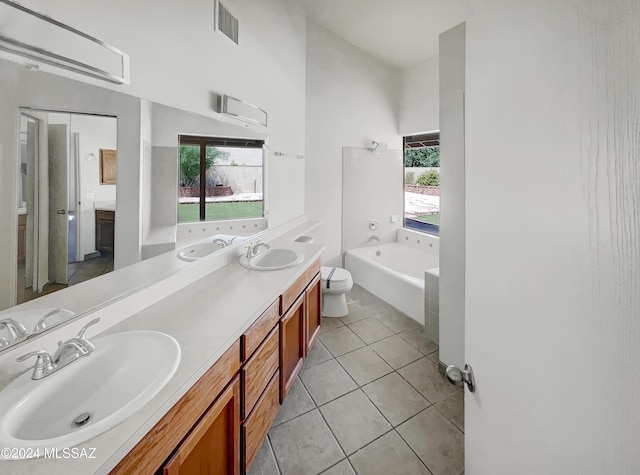 bathroom featuring tile patterned flooring, vanity, plenty of natural light, and a bathing tub