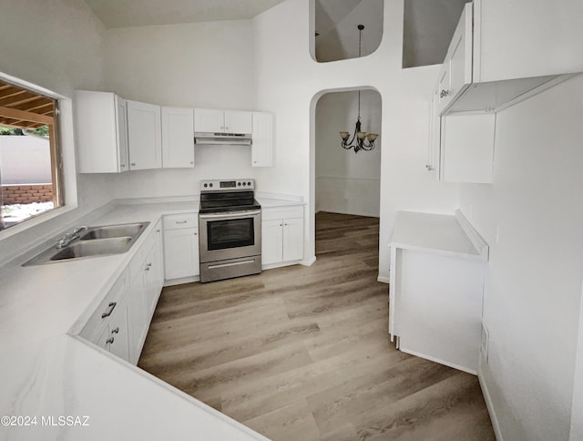 kitchen featuring sink, stainless steel range with electric cooktop, a notable chandelier, white cabinets, and light wood-type flooring