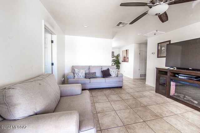 living room featuring light tile patterned floors, ceiling fan, and visible vents