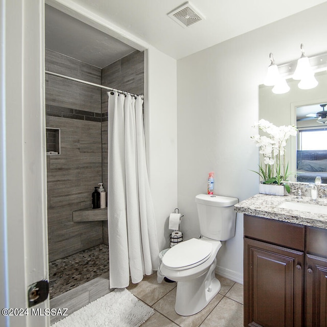 bathroom featuring vanity, a shower with curtain, tile patterned flooring, ceiling fan, and toilet