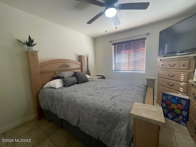 tiled bedroom featuring ceiling fan