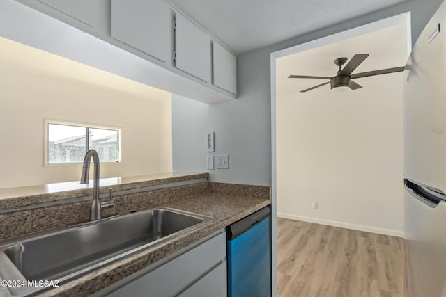 kitchen featuring stainless steel dishwasher, ceiling fan, sink, light hardwood / wood-style flooring, and white fridge