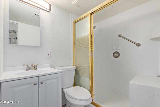 bathroom featuring vanity, toilet, and walk in shower