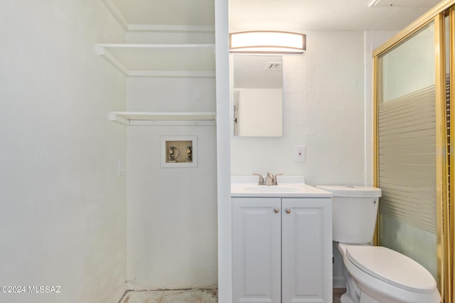 bathroom featuring vanity, an enclosed shower, and toilet