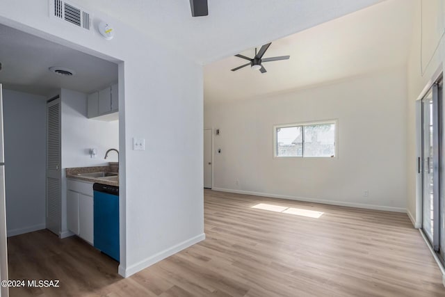 interior space with ceiling fan, sink, and light hardwood / wood-style floors