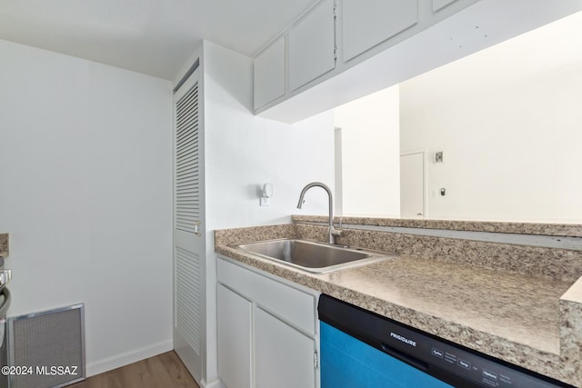 kitchen with dishwasher, wood-type flooring, and sink