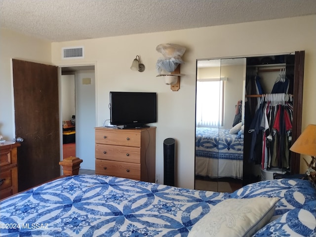 bedroom featuring a closet and a textured ceiling