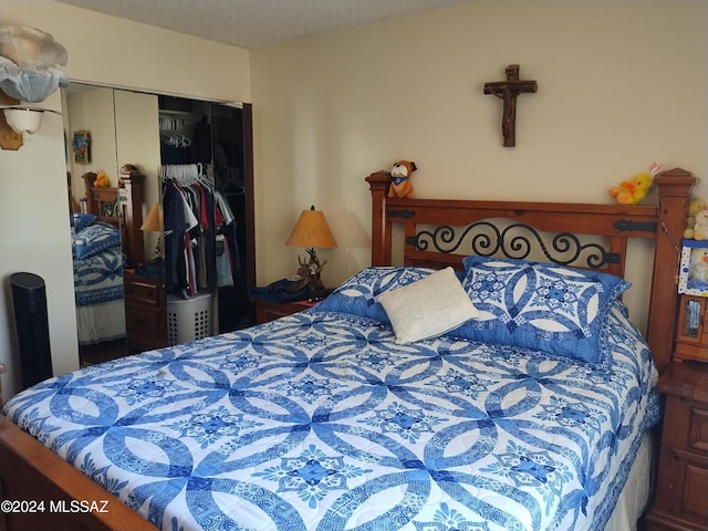 bedroom featuring a closet and a textured ceiling