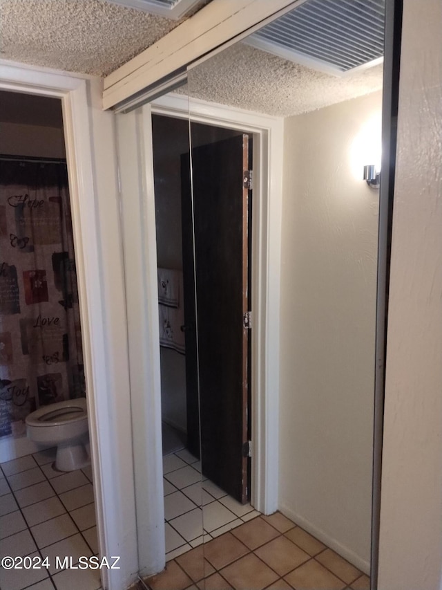 corridor featuring light tile patterned floors