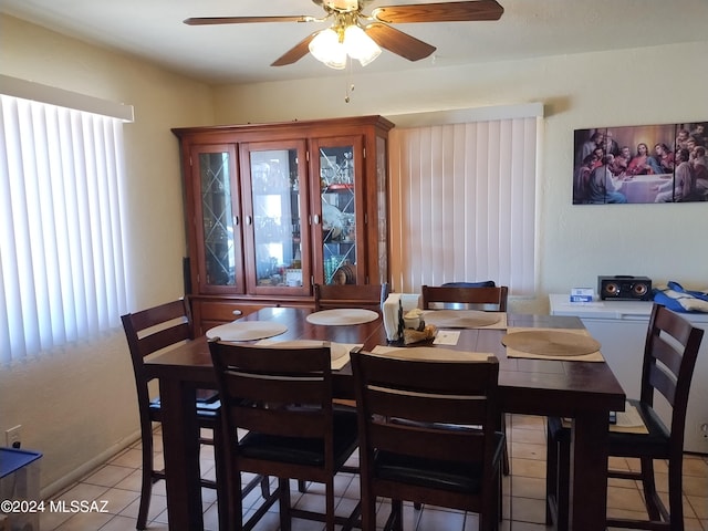 dining space featuring ceiling fan, a healthy amount of sunlight, and light tile patterned flooring