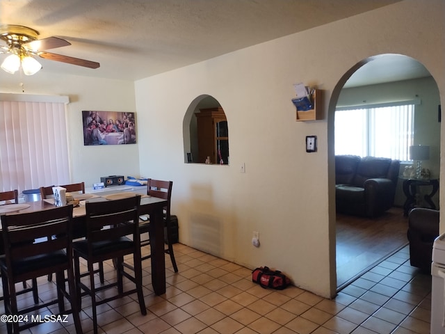 tiled dining area with ceiling fan