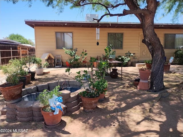 back of property with a patio