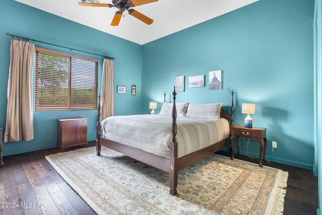 bedroom with ceiling fan and dark hardwood / wood-style flooring