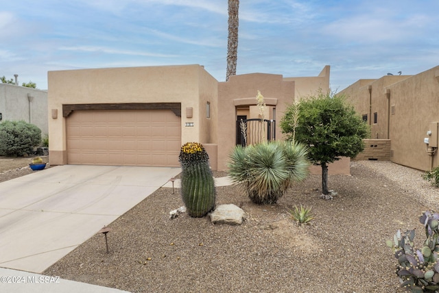 pueblo-style house with a garage