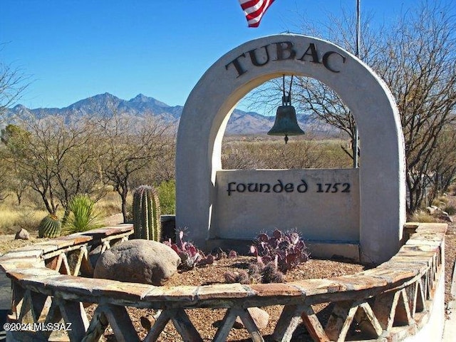 community sign with a mountain view