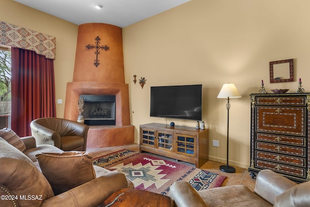 living room with light tile patterned floors and a large fireplace