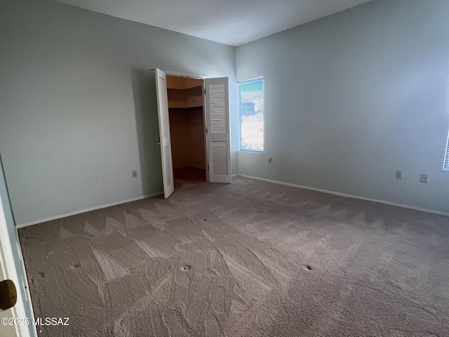 unfurnished bedroom with carpet and a closet