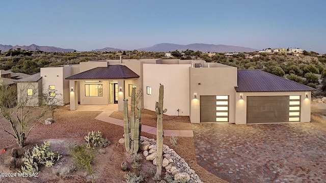 view of front of house with a garage and a mountain view