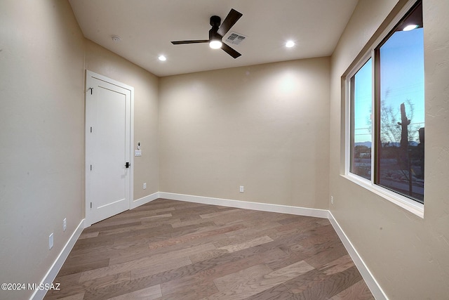 unfurnished room with hardwood / wood-style flooring and ceiling fan