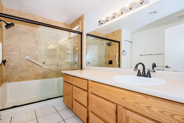 bathroom featuring shower / bath combination with glass door, tile patterned flooring, and vanity